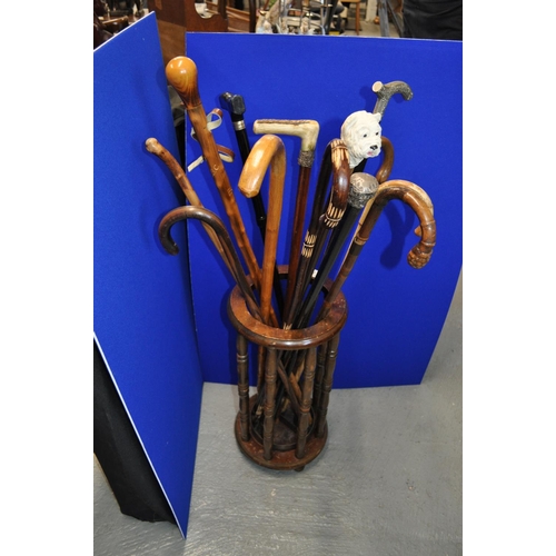 109 - A mixture of walking sticks/canes of varying styles, including two containing silver trims/decoratio... 