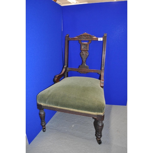 12 - Vintage Nursing Chair on castors, with carved wood detailing and green velour upholstery