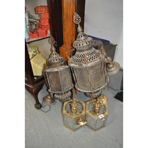 163 - Two Moroccan style metal lanterns with two other brass coloured and glass pendant lights