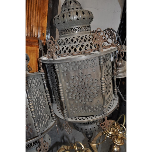 163 - Two Moroccan style metal lanterns with two other brass coloured and glass pendant lights