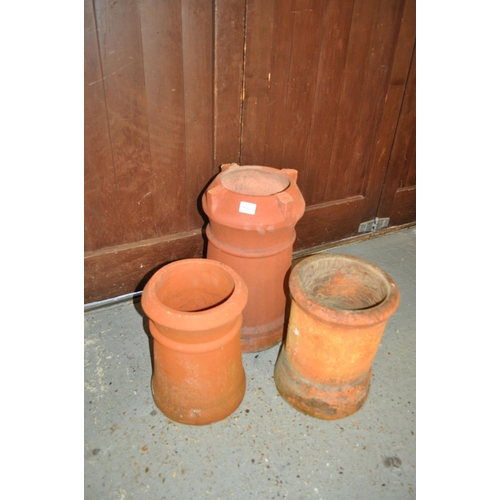 166 - Three cylindrical terracotta chimney pot style planters in varying sizes