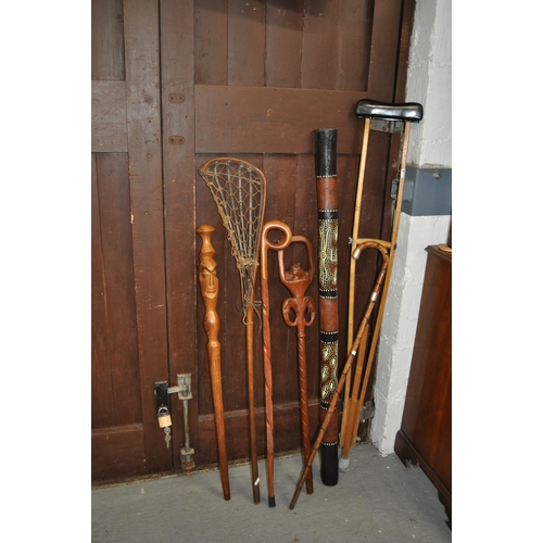 2 - A variety of wooden items including walking sticks, one features a silver collar, a digeridoo, a cru... 