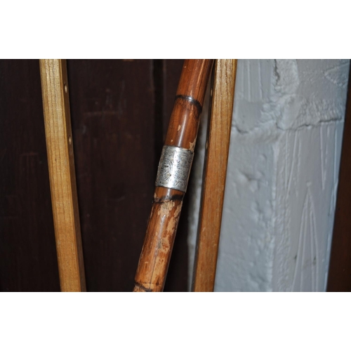 2 - A variety of wooden items including walking sticks, one features a silver collar, a digeridoo, a cru... 