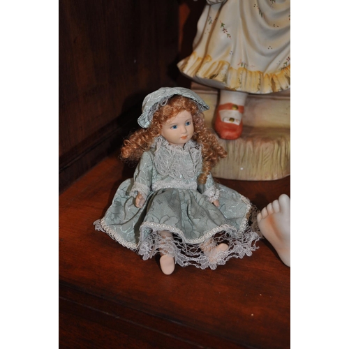 36 - Two bisque style children in Victorian attire together with a smaller jointed doll