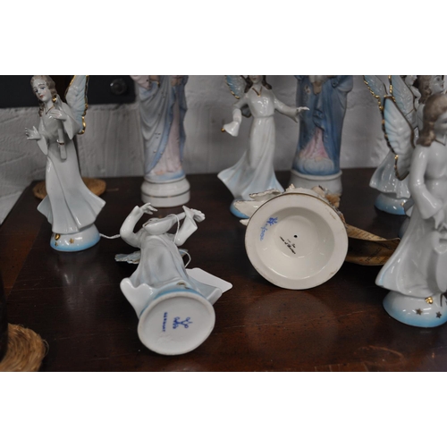 4 - German ceramic angelic figurines together with a period boy cherub holding a swan - a/f