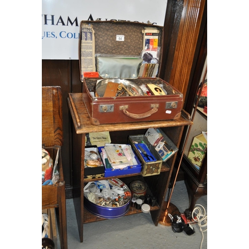 64 - Two tier shelving unit with gallery style top housing a large quantity of haberdashery items togethe... 