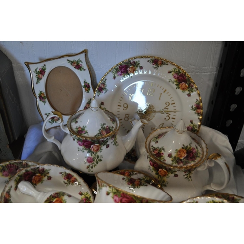 84 - A box of Royal Albert Country Roses porcelain items including; large and small teapots, cups, saucer... 