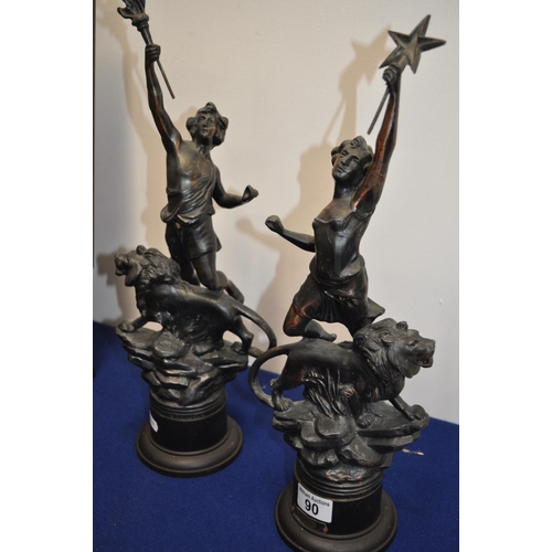 90 - Two spelter/cold bronze  style figures depicting  Olympic figures holding flame with lions