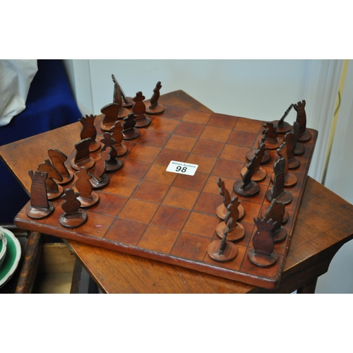 98 - Quirky leather chess board with leather chess pieces, board signed to base