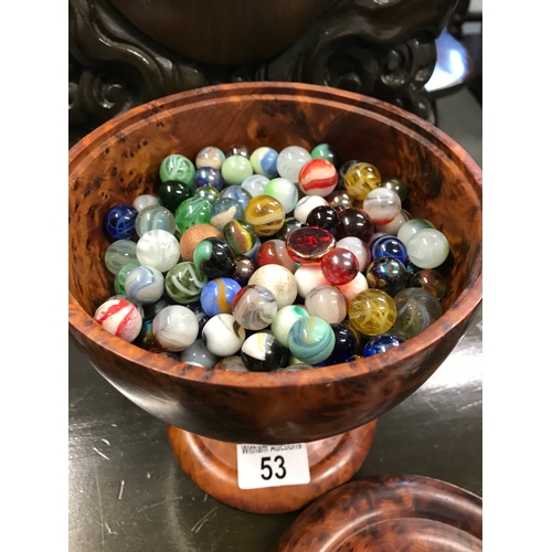 53 - Burr wood design lidded pot containing a quantity of marbles