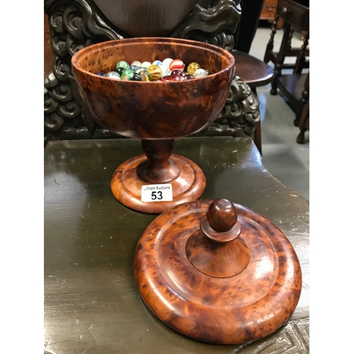 53 - Burr wood design lidded pot containing a quantity of marbles