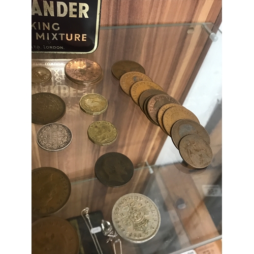 153 - A vintage tin containing a quantity of coins from around the world of various dates