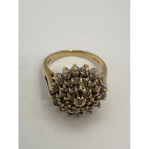 309 - A 9ct yellow gold CZ cluster ring, approx size M, Hallmarked London 375, makers stamp LMJ, approx we... 