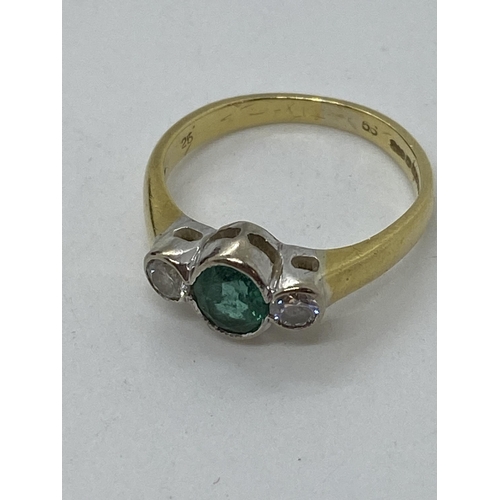 115 - A yellow gold ring, with central oval green  stone with two diamonds set either side, hallmarked Bir... 