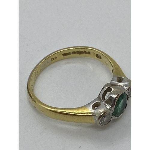 115 - A yellow gold ring, with central oval green  stone with two diamonds set either side, hallmarked Bir... 