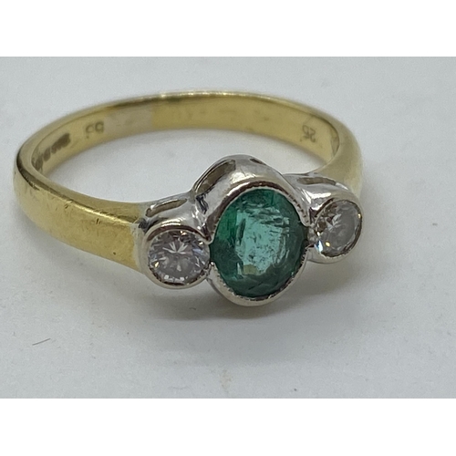 115 - A yellow gold ring, with central oval green  stone with two diamonds set either side, hallmarked Bir... 