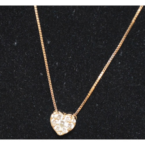 42 - A 14ct yellow gold heart shaped pendant (tested as 14ct gold) infilled with diamonds with 14k gold c... 