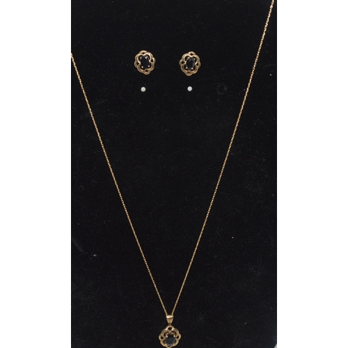 44 - 14ct yellow gold garnet necklace and earring set, the pendant features a central rectangular garnet ... 