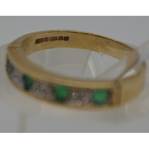 121 - A 9ct yellow gold diamond and emerald half eternity ring, hallmarked 375 Birmingham, approx size L