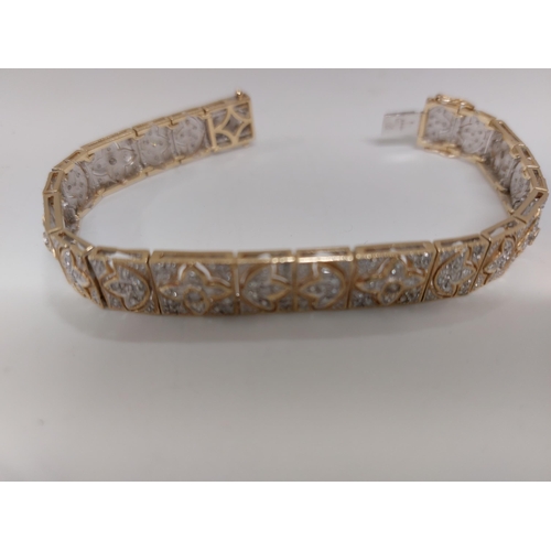 142 - Stunning 14ct gold and diamond cocktail bracelet with push clasp, design depicts multiple rows of di... 