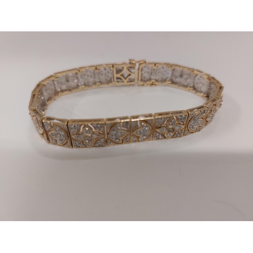 142 - Stunning 14ct gold and diamond cocktail bracelet with push clasp, design depicts multiple rows of di... 