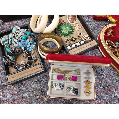 230 - A large quantity of costume jewellery including jewellery boxes, rings, earrings necklaces, brooches... 