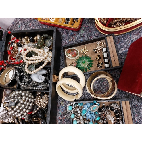 230 - A large quantity of costume jewellery including jewellery boxes, rings, earrings necklaces, brooches... 