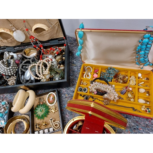 230 - A large quantity of costume jewellery including jewellery boxes, rings, earrings necklaces, brooches... 