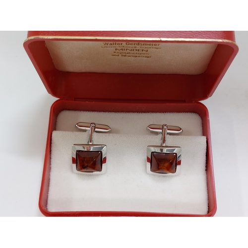 241 - A pair of amber and silver cufflinks stamped 800s presented in Walter Gerdsmeter box