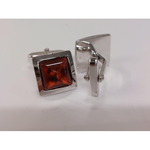 241 - A pair of amber and silver cufflinks stamped 800s presented in Walter Gerdsmeter box