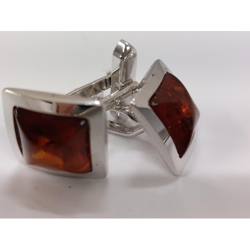 241 - A pair of amber and silver cufflinks stamped 800s presented in Walter Gerdsmeter box