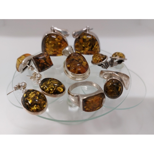 247 - A silver and amber jewellery bundle consisting of ring in a spiral shape design approx size L, A rin... 