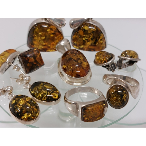 247 - A silver and amber jewellery bundle consisting of ring in a spiral shape design approx size L, A rin... 