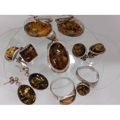 247 - A silver and amber jewellery bundle consisting of ring in a spiral shape design approx size L, A rin... 