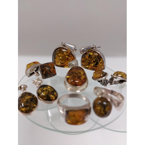 247 - A silver and amber jewellery bundle consisting of ring in a spiral shape design approx size L, A rin... 