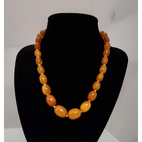 61 - Butterscotch amber necklace on silk cord, approx 20g