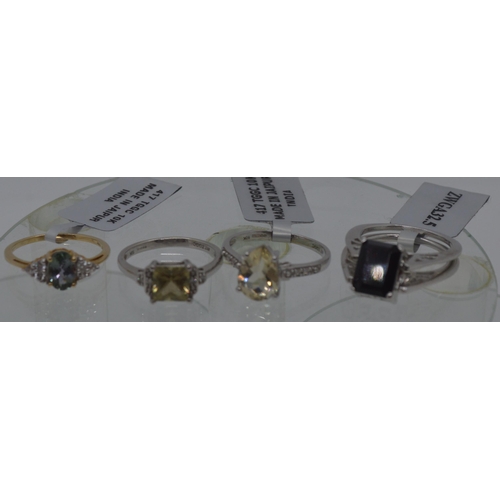 89 - Three modern TGGC gemstone white and yellow gold rings all marked 10k, plus one silver split ring wi... 