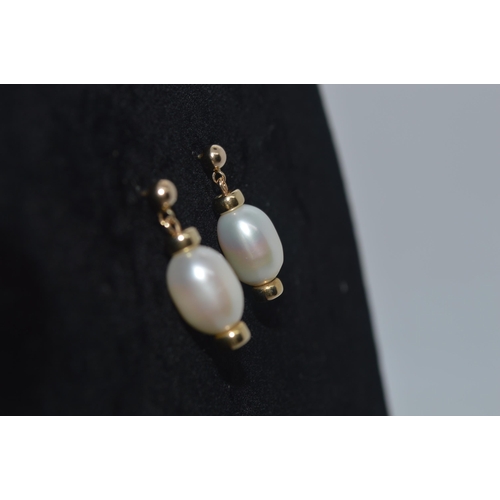 150 - A pair of bespoke 9ct yellow gold pearl stud drop earrings, unmarked tested as 9ct gold, gross weigh... 