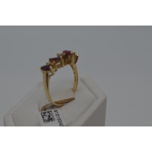 177 - A 14ct yellow gold ring in a wishbone design featuring marquise pink stone and diamonds, stamped 14k... 