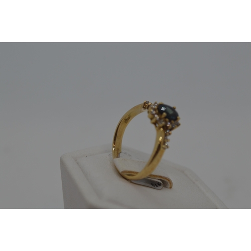 184 - 18ct yellow gold diamond and sapphire ring, approx size M/N.  Oval central sapphire approx .50ct, wi... 