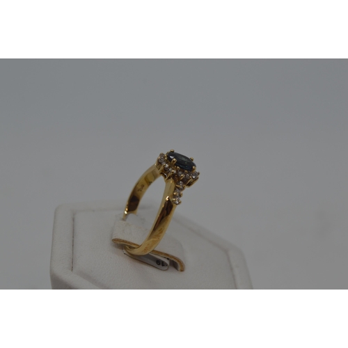 184 - 18ct yellow gold diamond and sapphire ring, approx size M/N.  Oval central sapphire approx .50ct, wi... 