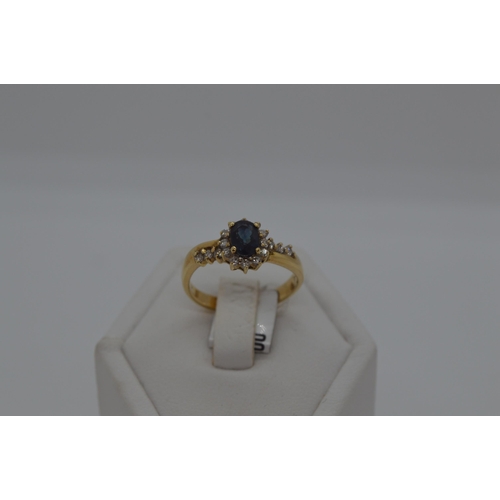 184 - 18ct yellow gold diamond and sapphire ring, approx size M/N.  Oval central sapphire approx .50ct, wi... 