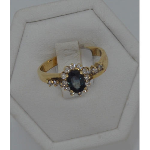 184 - 18ct yellow gold diamond and sapphire ring, approx size M/N.  Oval central sapphire approx .50ct, wi... 