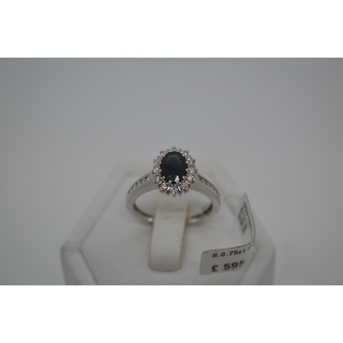 193 - 18ct white gold oval sapphire and diamond cluster ring with accent diamonds to shoulder , total appr... 