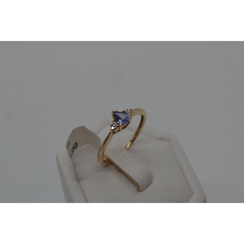 198 - 9ct yellow gold Tanzanite and diamond ring. Central Tanzanite stone of pear shaped form, hallmarked ... 