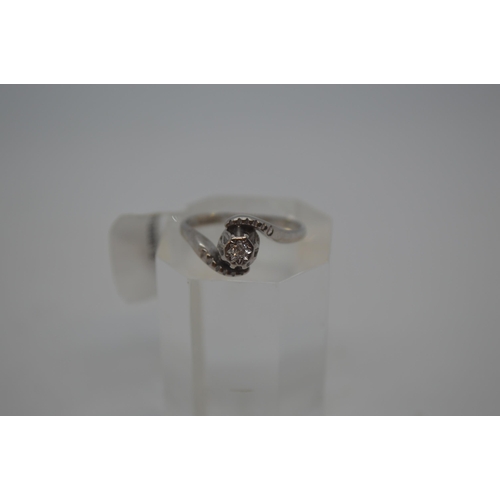 204 - 18ct white gold ring with central diamond stone 0.10ct in a swirl design, Hallmarked 18ct Birmingham... 