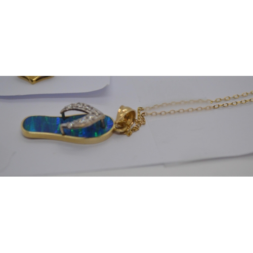 41 - A yellow gold pendant in the form of a flip flop with diamond detailing to the design, stamped 14K o... 