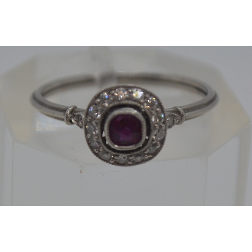 118 - Art deco style ring, raised central ruby with diamonds to surround, tested as 14ct white gold, marke... 