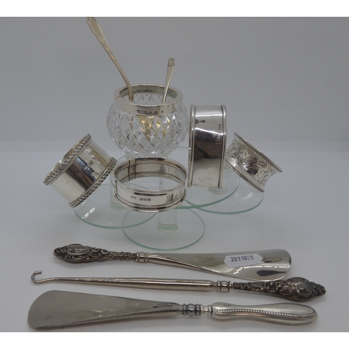 269 - A selection of silver items including x3 circular and heart shaped napkin rings, spoon with flower d... 