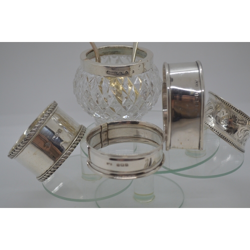 269 - A selection of silver items including x3 circular and heart shaped napkin rings, spoon with flower d... 